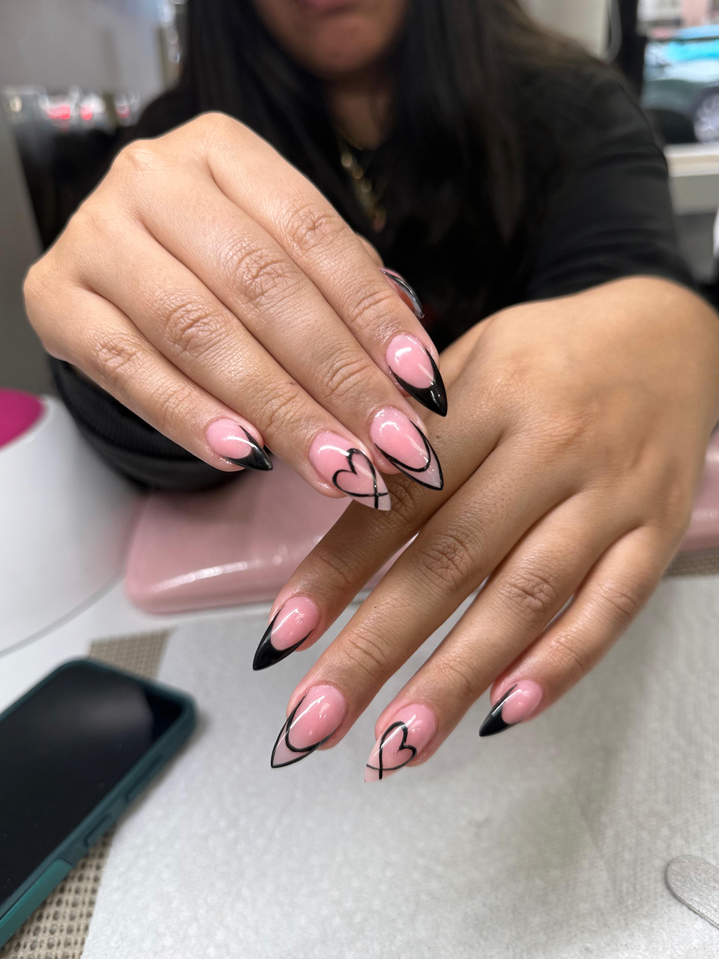 Pink almond nails with black heart art